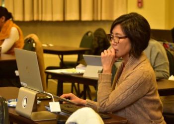 A faculty member on her laptop