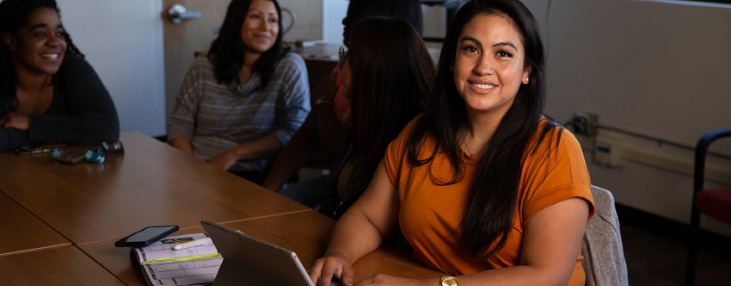 A Latina student on her laptop.