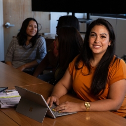 A Latina student on her laptop.