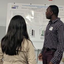 Two persons looking at a poster in a symposium